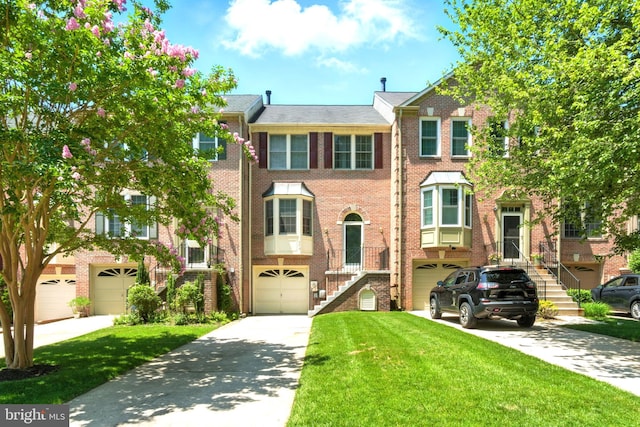 673 Budleigh Cir, Lutherville Timonium, MD 21093 - multi unit property featuring driveway, a garage, brick siding, stairs, and a front yard