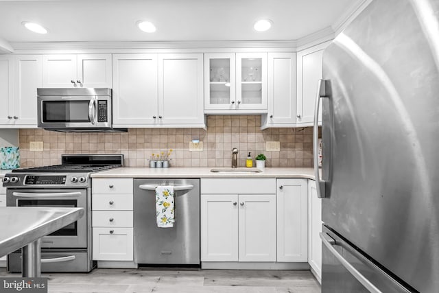 801 Yale Ave Unit 617, Swarthmore, PA 19081 - kitchen with appliances with stainless steel finishes, white cabinetry, light wood-style flooring, light countertops, and recessed lighting