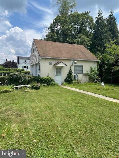 17 Rhode Island Ave, Cherry Hill, NJ 08002 - view of front of house with a garage, stucco siding, and a front lawn
