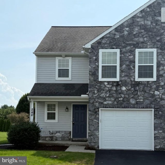 248 S Village Cir, Palmyra, PA 17078 - view of front of property with stone siding, a shingled roof, driveway, and an attached garage