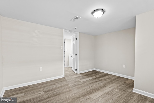 2328 E Hoffman St, Baltimore, MD 21213 - empty room with wood finished floors and a smoke detector