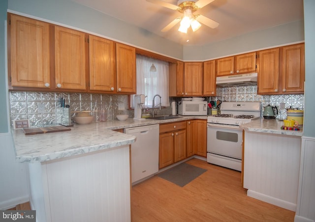 103 David Rd, Wilmington, DE 19804 - kitchen with white appliances, under cabinet range hood, light wood-style floors, a ceiling fan, and decorative backsplash