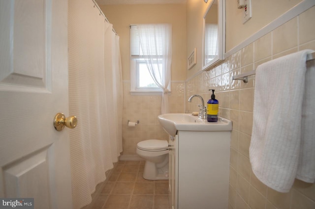 103 David Rd, Wilmington, DE 19804 - full bath with tile walls, vanity, tile patterned floors, curtained shower, and wainscoting