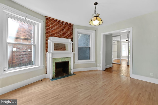 1223 Euclid St NW, Washington, DC 20009 - unfurnished living room featuring light wood-type flooring and a large fireplace