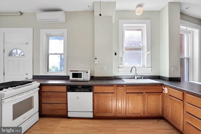 1223 Euclid St NW, Washington, DC 20009 - kitchen with white appliances, a wall mounted air conditioner, and brown cabinets