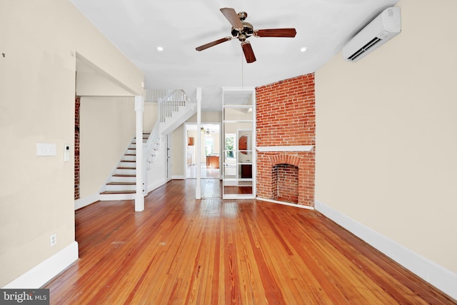 1223 Euclid St NW, Washington, DC 20009 - unfurnished living room with a wall mounted AC, ceiling fan, stairway, wood-type flooring, and recessed lighting