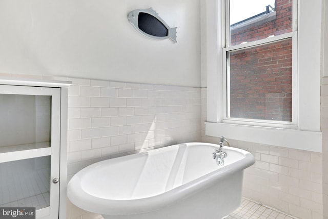 1223 Euclid St NW, Washington, DC 20009 - full bath with tile walls, a freestanding tub, a wainscoted wall, and tile patterned floors