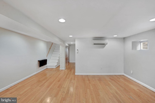 1223 Euclid St NW, Washington, DC 20009 - below grade area featuring a wall unit AC, stairs, wood finished floors, and recessed lighting