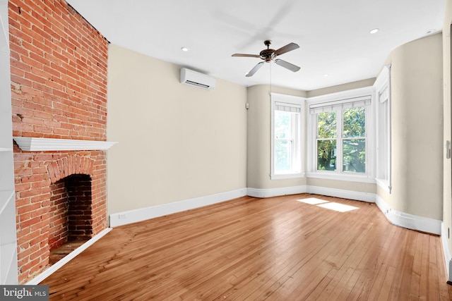 1223 Euclid St NW, Washington, DC 20009 - unfurnished living room featuring a wall unit AC, light wood finished floors, ceiling fan, a fireplace, and recessed lighting