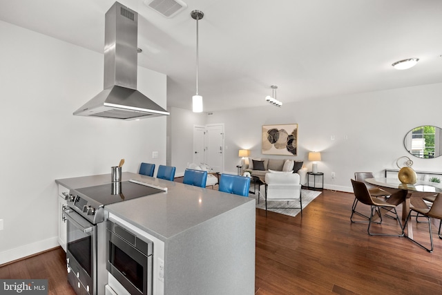 1411 Key Blvd Unit 411, Arlington, VA 22209 - kitchen with island exhaust hood, appliances with stainless steel finishes, dark wood-style floors, decorative light fixtures, and open floor plan