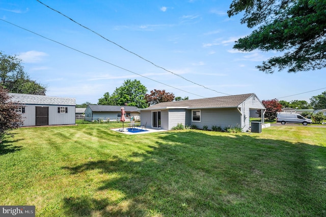 41 Good Ln, Levittown, PA 19055 - rear view of house featuring a lawn, an outdoor structure, and a patio area