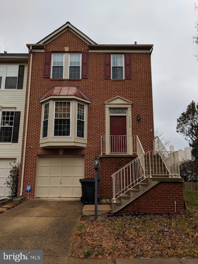 46838 Graham Cove Sq, Sterling, VA 20165 - view of property with driveway, a garage, and brick siding