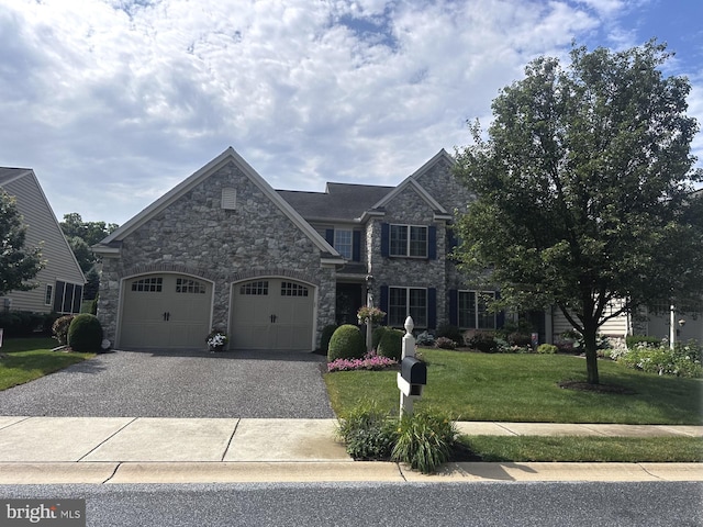 7575 Forney Way, Harrisburg, PA 17112 - view of front of house featuring stone siding, gravel driveway, a front lawn, and an attached garage
