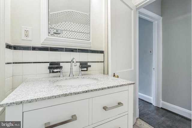 2504 Parkview Rd, Baltimore, MD 21207 - bathroom with vanity, wood finished floors, and decorative backsplash