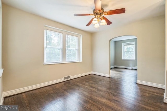 2504 Parkview Rd, Baltimore, MD 21207 - spare room with arched walkways, dark wood-style floors, and a ceiling fan