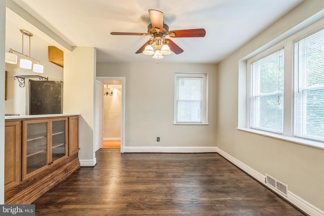 2504 Parkview Rd, Baltimore, MD 21207 - unfurnished living room with healthy amount of natural light, dark wood-style floors, and ceiling fan