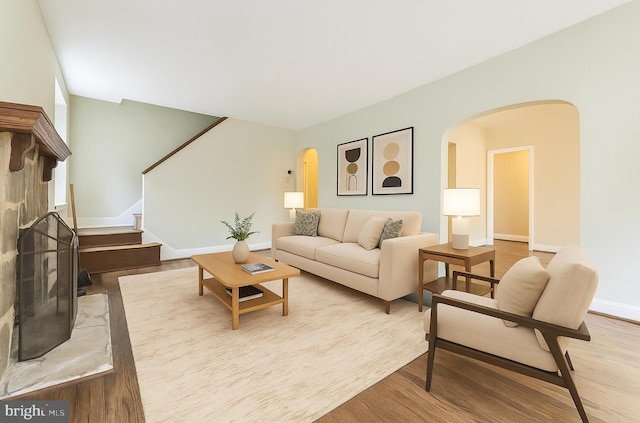 2504 Parkview Rd, Baltimore, MD 21207 - living room with arched walkways, stairs, and wood finished floors