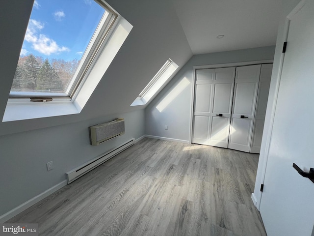 106 Lynx Ln, Effort, PA 18330 - bonus room with baseboard heating, a skylight, light wood-type flooring, and an AC wall unit