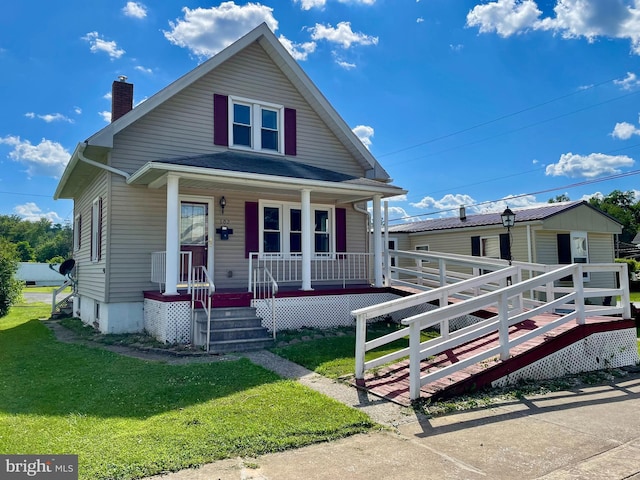 502 S Juniata St, Lewistown, PA 17044 - view of front of home featuring a chimney, covered porch, and a front yard
