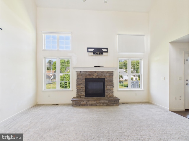 53 Hamlet Cir, Mechanicsburg, PA 17050 - unfurnished living room with carpet flooring, a towering ceiling, healthy amount of natural light, and a fireplace