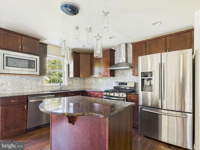 53 Hamlet Cir, Mechanicsburg, PA 17050 - kitchen with appliances with stainless steel finishes, wall chimney range hood, a center island, dark wood finished floors, and dark stone countertops