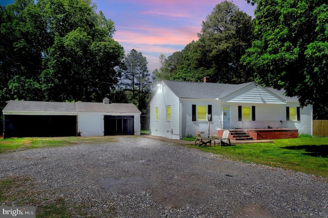 10439 Ashcake Rd, Ashland, VA 23005 - ranch-style house featuring gravel driveway, an outbuilding, a chimney, covered porch, and a yard