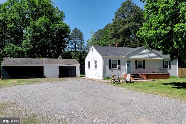 10439 Ashcake Rd, Ashland, VA 23005 - single story home with a garage, an outdoor structure, a front yard, covered porch, and a shingled roof