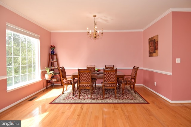 43696 Phelps Ter, Ashburn, VA 20147 - dining room with a chandelier, wood finished floors, plenty of natural light, and crown molding