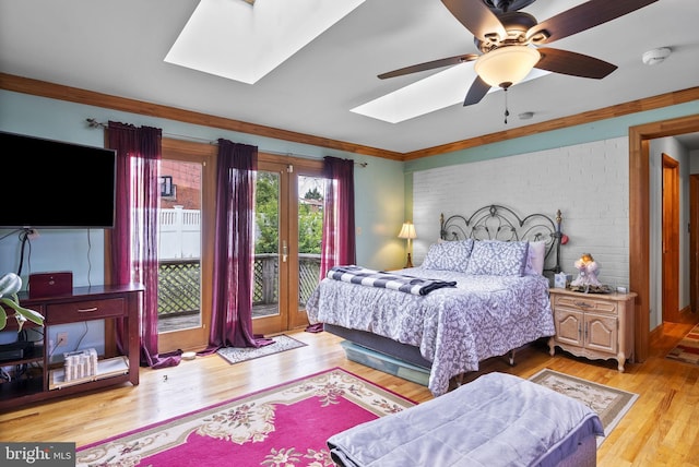 8426 Coco Rd, Baltimore, MD 21237 - bedroom featuring a skylight, access to outside, light wood-style flooring, ornamental molding, and a ceiling fan