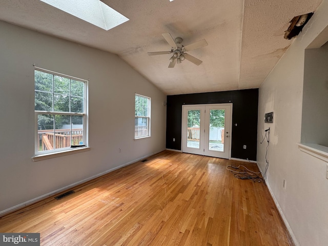 1809 Labrott Ln, Annapolis, MD 21401 - unfurnished room featuring a skylight, wood finished floors, a ceiling fan, a textured ceiling, and vaulted ceiling