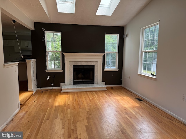 1809 Labrott Ln, Annapolis, MD 21401 - unfurnished living room featuring a skylight, light wood finished floors, healthy amount of natural light, and lofted ceiling