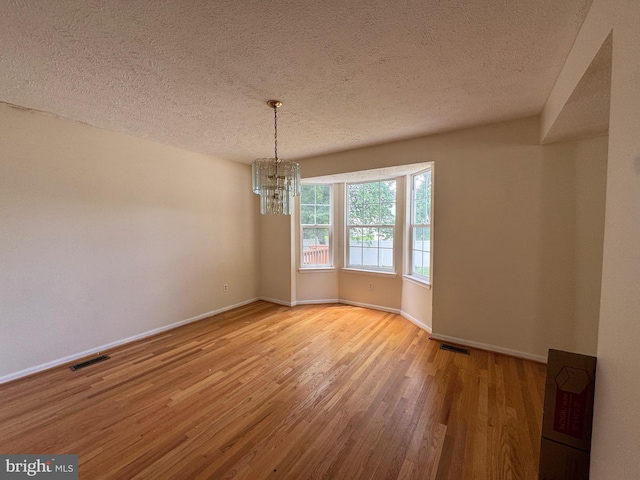 1809 Labrott Ln, Annapolis, MD 21401 - spare room with a chandelier, wood finished floors, and a textured ceiling