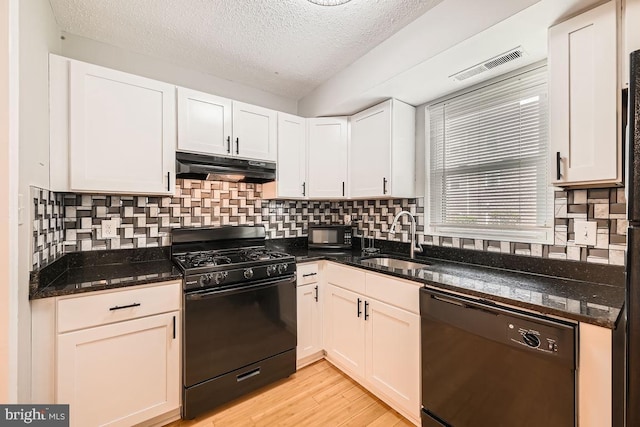 11921 Tarragon Rd Unit F, Reisterstown, MD 21136 - kitchen with black appliances, under cabinet range hood, a textured ceiling, white cabinetry, and light wood-style flooring