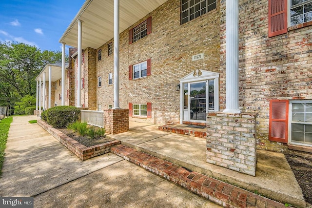 11921 Tarragon Rd Unit F, Reisterstown, MD 21136 - doorway to property featuring brick siding and a porch