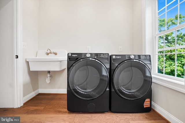 3722 13th St NE, Washington, DC 20017 - laundry area featuring washing machine and clothes dryer and wood finished floors