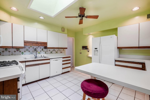 4901 Ashby St NW, Washington, DC 20007 - kitchen featuring white appliances, light countertops, white cabinetry, a ceiling fan, and backsplash