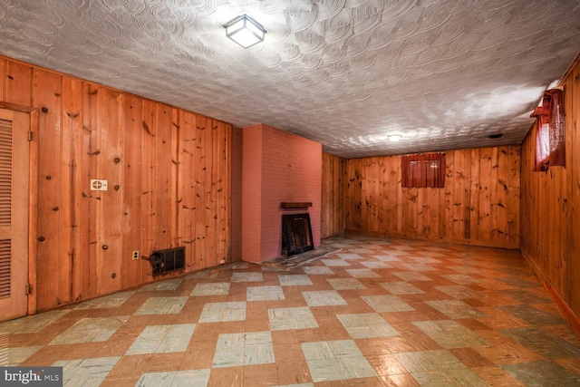4901 Ashby St NW, Washington, DC 20007 - finished below grade area with wooden walls, a brick fireplace, light floors, and an ornate ceiling