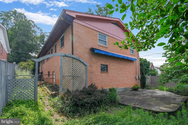 4901 Ashby St NW, Washington, DC 20007 - view of home's exterior with brick siding and a patio