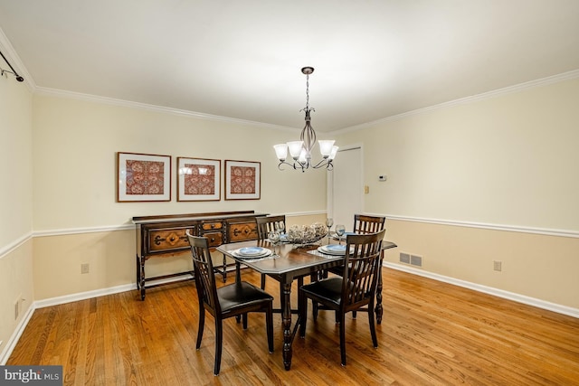707 Pheasant Run, Kennett Square, PA 19348 - dining room featuring a chandelier, crown molding, and wood finished floors