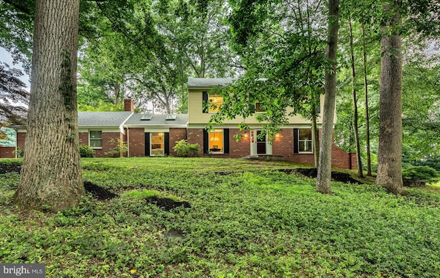 707 Pheasant Run, Kennett Square, PA 19348 - colonial house with brick siding, a chimney, and a front yard