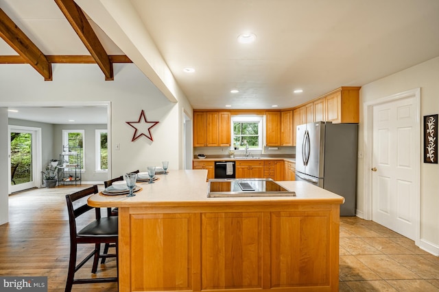 707 Pheasant Run, Kennett Square, PA 19348 - kitchen with black appliances, light countertops, recessed lighting, beam ceiling, and a breakfast bar
