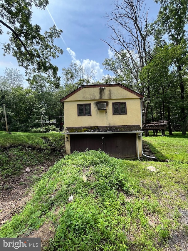 93 Jacobs Creek Rd, Ewing, NJ 08628 - view of side of home with stucco siding, a deck, and a wall mounted air conditioner
