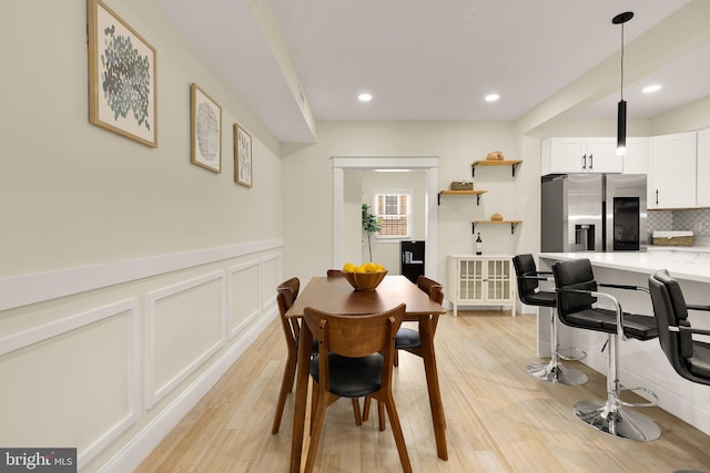 4902 3rd St NW, Washington, DC 20011 - dining area with light wood-type flooring, a decorative wall, recessed lighting, and a wainscoted wall
