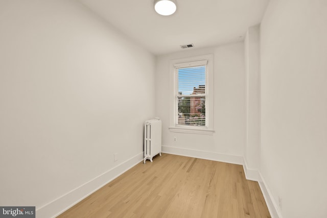 1371 Perry Pl NW, Washington, DC 20010 - unfurnished room with radiator and light wood-style floors