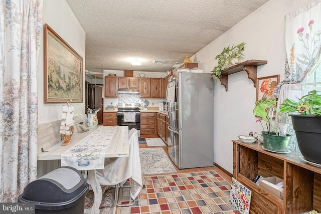 16 Pin Oak Dr, Atco, NJ 08004 - kitchen featuring appliances with stainless steel finishes, brown cabinets, under cabinet range hood, light countertops, and a textured ceiling