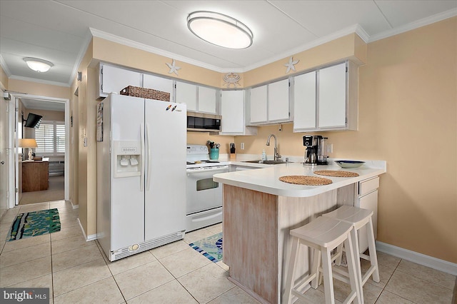 778 94th St Unit 205, Ocean City, MD 21842 - kitchen with white appliances, a peninsula, crown molding, light tile patterned floors, and light countertops