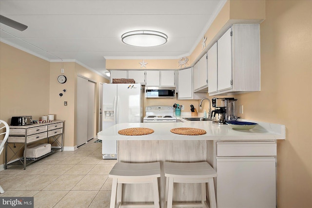 778 94th St Unit 205, Ocean City, MD 21842 - kitchen with white appliances, light countertops, ornamental molding, a peninsula, and light tile patterned flooring