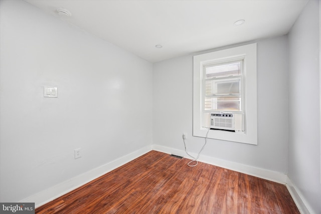 1217 Vandever Ave, Wilmington, DE 19802 - empty room featuring cooling unit, dark wood-style floors, and a smoke detector