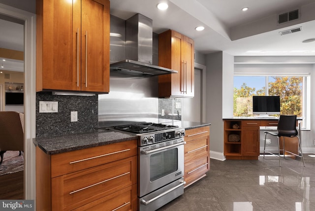 2230 California St NW Unit 5Cw, Washington, DC 20008 - kitchen featuring gas range, wall chimney range hood, backsplash, brown cabinetry, and dark stone counters