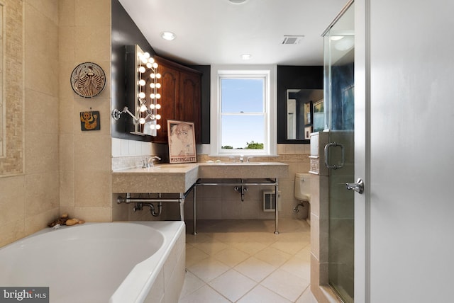 2230 California St NW Unit 5Cw, Washington, DC 20008 - bathroom with tile walls, tile patterned floors, a garden tub, and a shower stall
